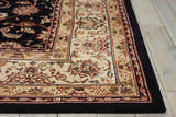 Close up of the navy Nourison 2000 Persian rug showing its floral pattern and handmade texture. Clearance.