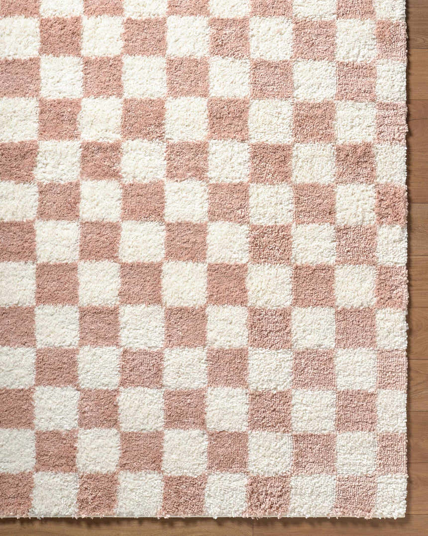 Close-up of the Bilshivtsi Area Rug. Plush, machine-woven rug with a pink and white checkerboard pattern. Swatch