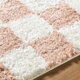 Close up of the Bilshivtsi Area Rug showing a plush, textured pile in a pink and white geometric pattern. Texture