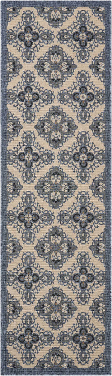 Close-up of Nourison Caribbean Ivory Blue rug. Contemporary floral pattern in blue and chestnut on an ivory background.