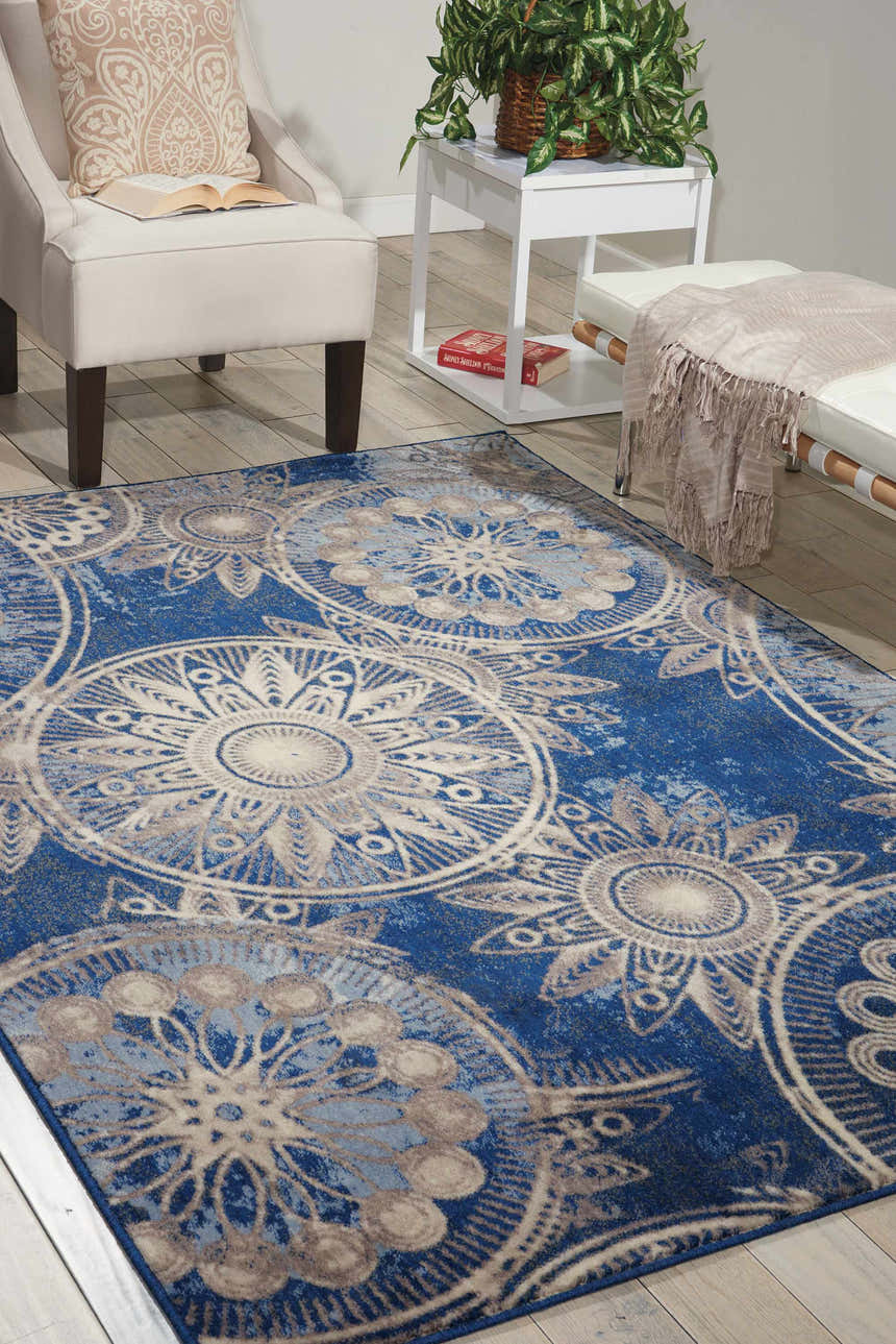 Living room scene with a Nourison Somerset Denim rug, white armchair, and light wood floors.