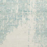 Close-up of the Nourison Harmony Ivory Aqua rug featuring a modern abstract pattern and soft, wool-rayon texture.