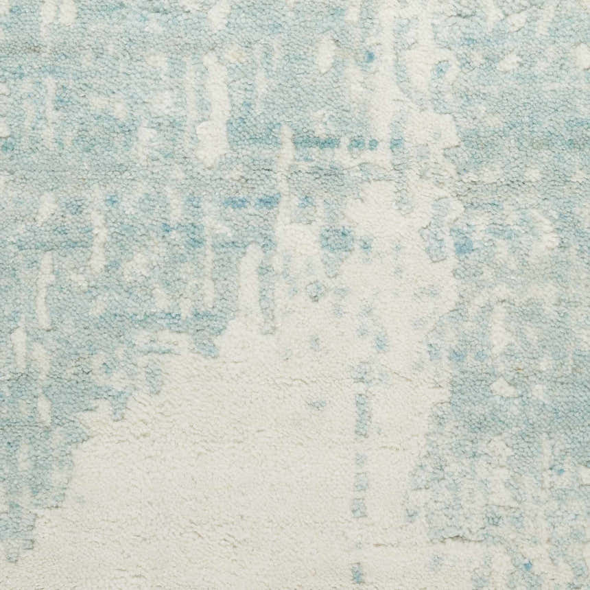 Close-up of the Nourison Harmony Ivory Aqua rug featuring a modern abstract pattern and soft, wool-rayon texture.