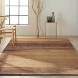 Minimalist room with caramel Calvin Klein Home Luster Wash rug, wood chair, and copper accent table.