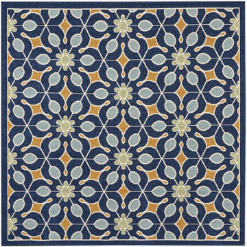 Close-up of Nourison Caribbean Navy rug. Mid-century modern style with floral, diamond, and teardrop shapes in navy, gold, and light blue.