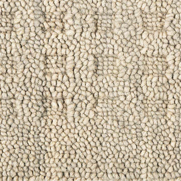 Close-up of the textured, ivory Nourison Marana Taupe rug. Handmade wool rug with a contemporary pebble-like design.