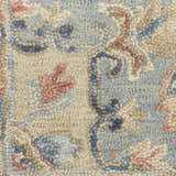 Close-up of the Nourison Maison Ivory Rust rug. Vintage design with chestnut, blue, and pink floral pattern. Handmade pile texture.