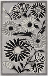 Close-up of the Nourison Aloha Black White Outdoor Area Rug featuring a floral design with black, white, and gray flowers.