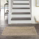 Farmhouse foyer with Nourison Terrazzo Jute Natural Grey rug on wood floor. Staircase and modern console table.