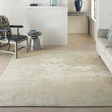 Living room scene with a Nourison Twilight Ivory Green rug, light gray sofa, and modern decor.