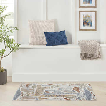 Nourison Astra Ivory Kids Rug in a bright entryway with pillows, throw, art, and plant. Playful and inviting.