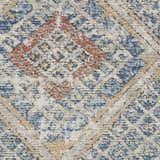 Close-up of Nourison Quarry Blue Ivory Southwestern Rug. Chestnut, blue, and ivory diamond pattern. Soft, textured pile.