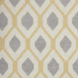 Close up of the Nourison Grafix White rug featuring a geometric diamond pattern in off-white, gray, and light yellow.