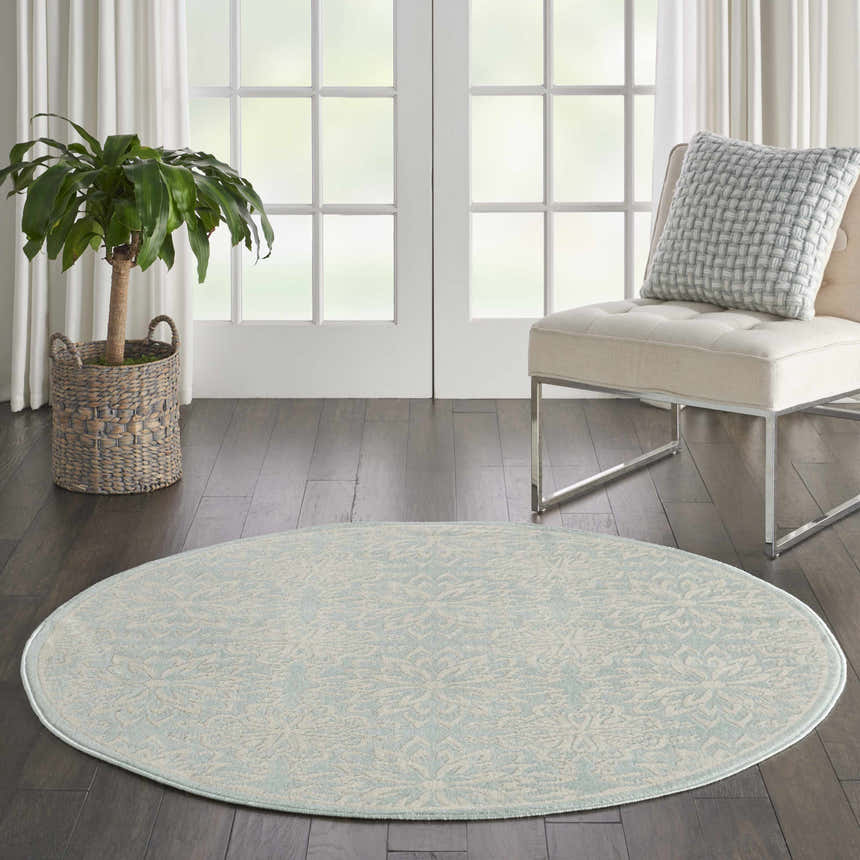 Room scene with round Nourison Jubilant Ivory Green rug, chair, plant, and white french doors. Farmhouse style.
