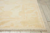 Close-up of Nourison Silk Pointe Ivory Vintage rug with chestnut floral pattern and fringe detail. Wool rug.