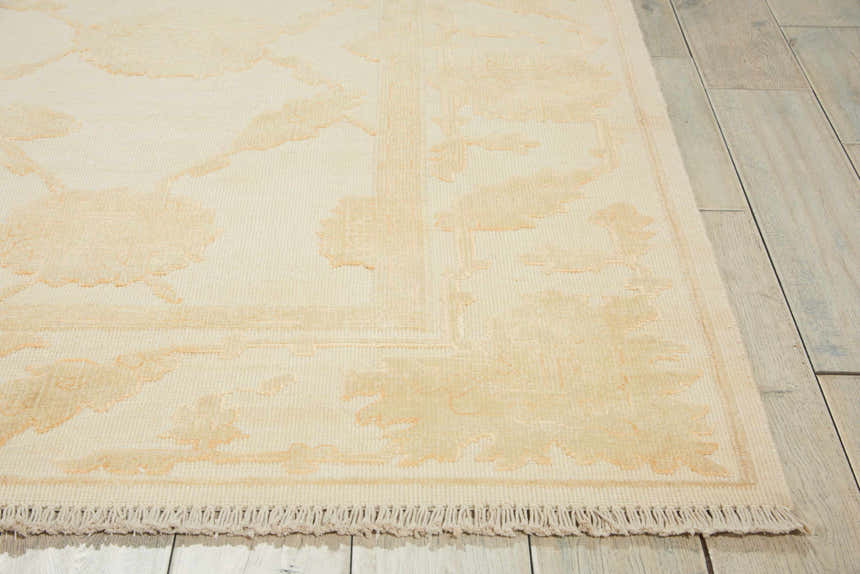 Close-up of Nourison Silk Pointe Ivory Vintage rug with chestnut floral pattern and fringe detail. Wool rug.