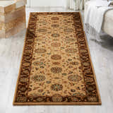 Living room scene with a Nourison Living Treasures Beige Traditional rug, neutral sofa, and wood floors.