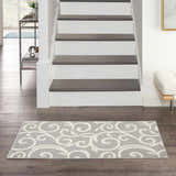 Entryway with Nourison Grafix Grey Contemporary Indoor Area Rug runner, hardwood floors, and staircase.