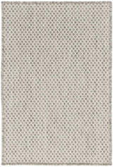 Close-up of the Nourison Courtyard Ivory Silver rug. Features a diamond pattern and fringed edges.