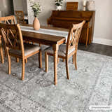 Farmhouse dining room with wood table and Davina Becki Owens rug in charcoal, light gray, and white. Roomscene-Rectangle