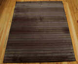 Close-up of the Nourison Aura Chocolate rug. Modern design with horizontal stripes in shades of brown. Luxcelle and cotton texture.