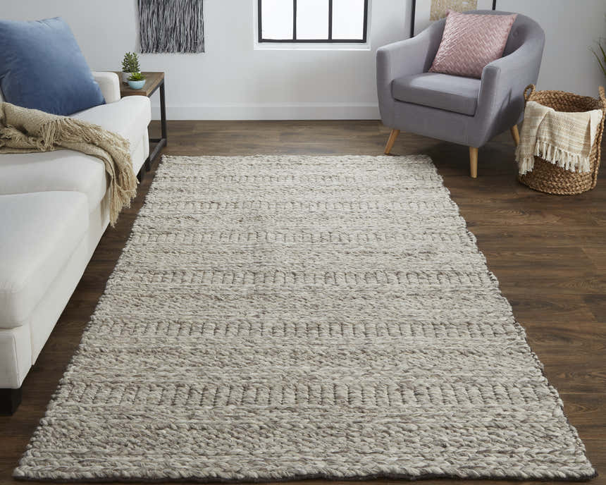 Living room scene with a Feizy Berkeley ivory and gray rug, white sofa, and gray armchair. Roomscene-Rectangle