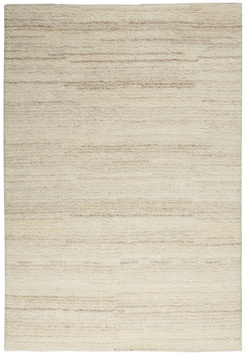 Close-up of the beige Calvin Klein Agadir shag rug. Handmade wool rug with a soft, textured pile and subtle horizontal stripes.