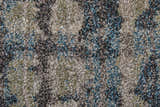 Close-up of the Feizy Skyview rug. Abstract design in gray, black, ivory, and blue tones. Soft, textured pile. Texture