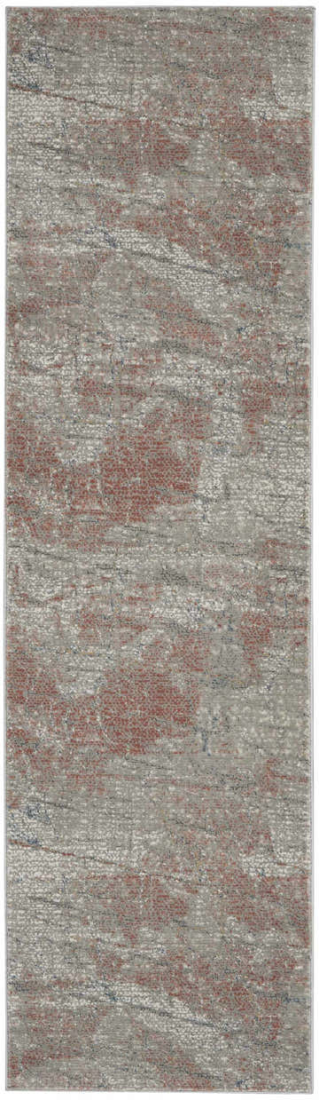 Close-up of Nourison Rustic Textures Light Grey Rust rug. Modern design with gray, rust, and subtle blue tones.