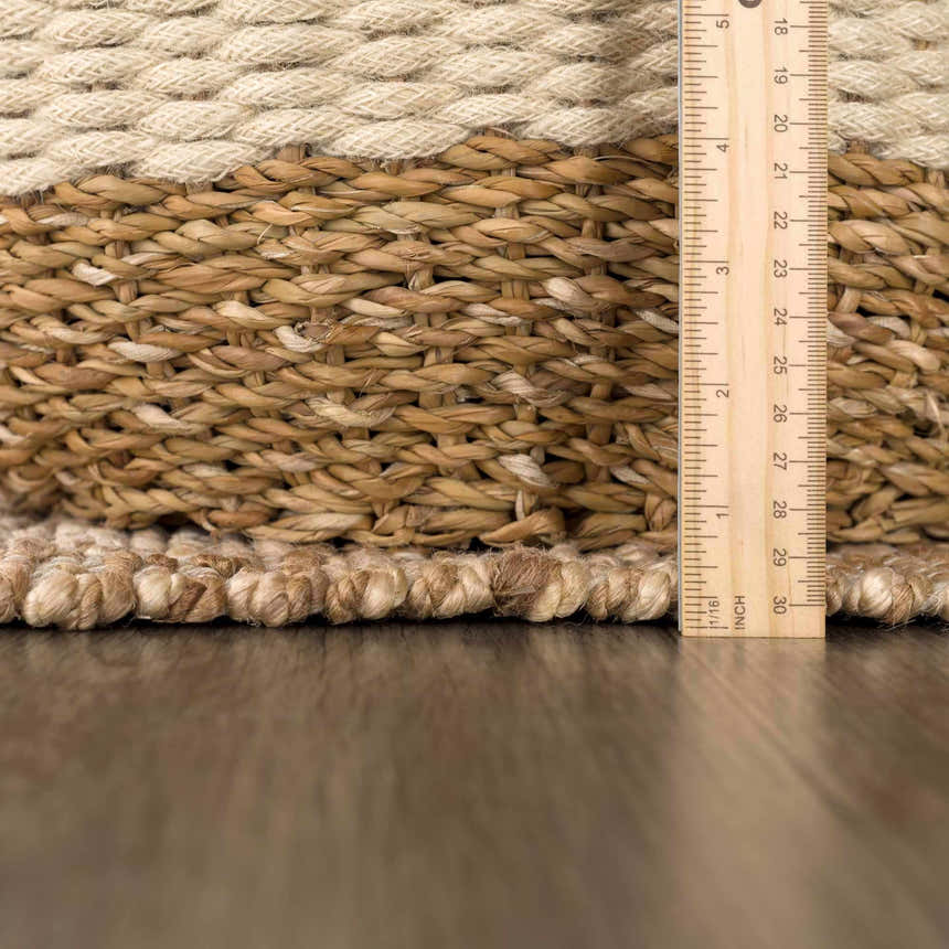 Close-up of the hand woven Ionut Checkered Jute Area Rug showing beige, tan colors and texture with a ruler for scale. Pile