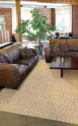 Loft living room with leather sofas and a Nourison Capri Beige Floral Indoor Area Rug.