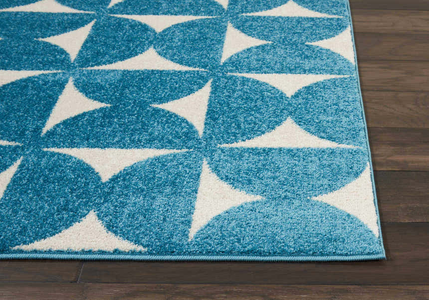 Close up of Nourison Harper Blue Colorful Area Rug with a geometric half-circle and triangle pattern.