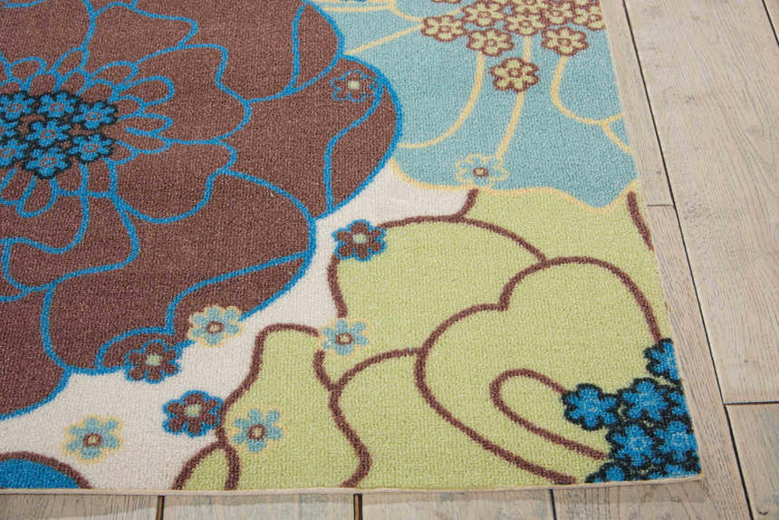 Close-up of the Nourison Home & Garden Light Blue rug. Features a floral pattern in light blue, brown, and green hues.