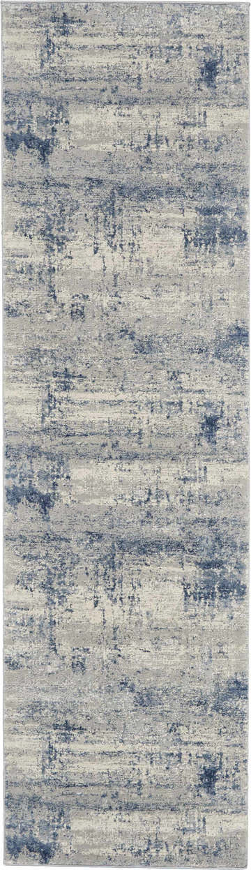 Close-up of the Nourison Rustic Textures Ivory Blue area rug featuring a distressed, modern pattern.