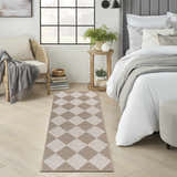 Bedroom scene with Nourison Modern Jute Natural Ivory rug. Chestnut diamond pattern on light wood floors, neutral decor.