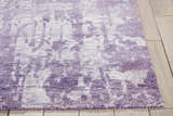 Close-up of the Nourison Silk Shadows Amethyst rug. Vintage style rug in shades of purple with distressed pattern and soft texture.