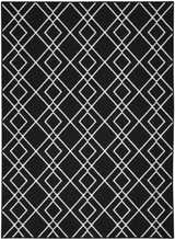 Close-up of the Nourison Modern Lines Black rug, featuring a geometric diamond pattern in white on a black background.