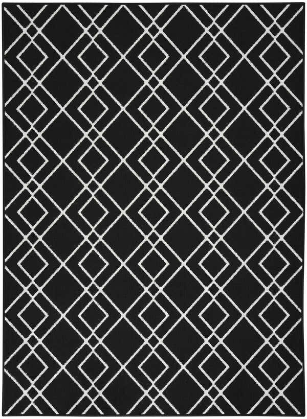 Close-up of the Nourison Modern Lines Black rug, featuring a geometric diamond pattern in white on a black background.