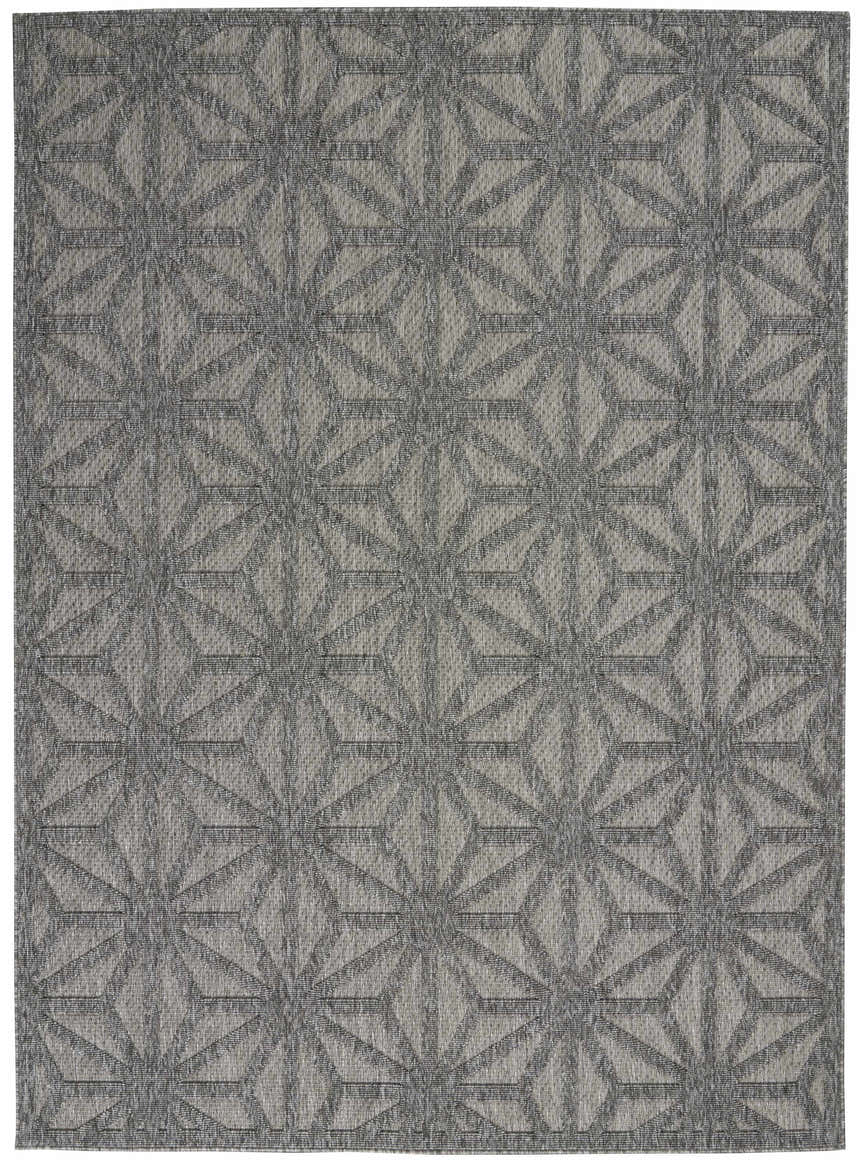 Close-up of Nourison Cozumel Dark Grey rug. Mid-century modern style with geometric star pattern in shades of gray.