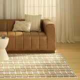 Living room scene with a brown leather sofa and Nourison Nordic Multicolor Area Rug.