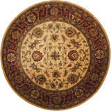 Close-up of round Nourison Jaipur Light Gold rug. Handmade wool rug with floral pattern in light gold, red, and green.