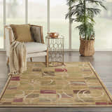 Living room scene with a Nourison Expressions Beige rug, chair, side table, and plant. Modern style.