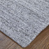 Close-up of the hand-knotted Feizy Finley Gray/Ivory area rug showing texture and color variations. Corner