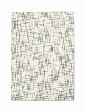 Close-up of Calvin Klein Tucson Ivory/Light Grey rug. Abstract, textured wool rug with a mid-century modern design.