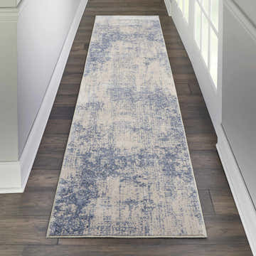 Hallway with Nourison Silky Textures Ivory/Blue runner rug on dark wood floor, white walls and trim.