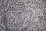 Close-up of the Feizy Stoneleigh Modern Solid Area Rug in gray and silver, showing its plush, hand-tufted texture. Texture