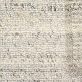 Close-up of the Calvin Klein CK082 Ridge rug. Grey and ivory wool rug with a textured, handmade weave.