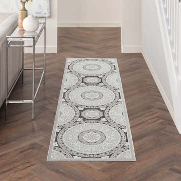 Hallway with Nourison Key Largo Grey Contemporary Area Rug runner, wood floors, console table.
