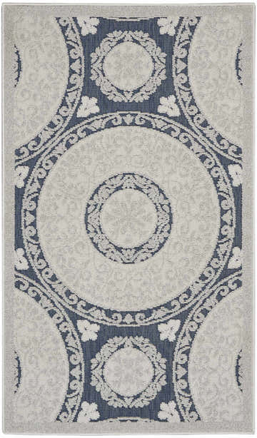 Close-up of Nourison Key Largo Blue Contemporary Area Rug. Features a circular, floral pattern in light blue and navy.