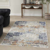 Modern living room with a Nourison Motion Blue Multicolor rug, black chairs, and wood console table.